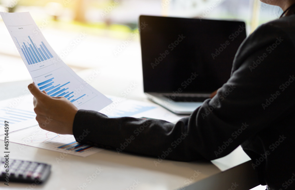 Business man holding business report paperwork and business data analysis.