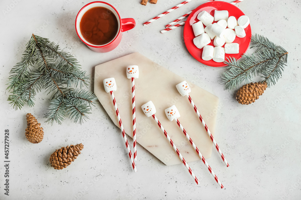 Snowmen made of soft marshmallows on light background