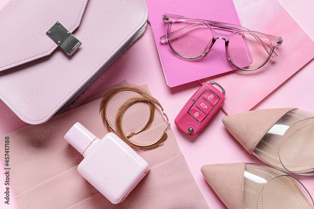 Stylish female accessories on pink background