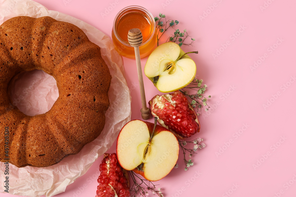 Bread with honey, pomegranate and apple on color background. Rosh hashanah (Jewish New Year) celebra