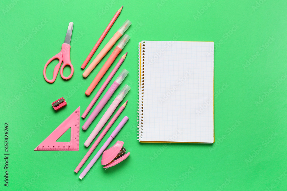 Stationery supplies and blank notebook on color background