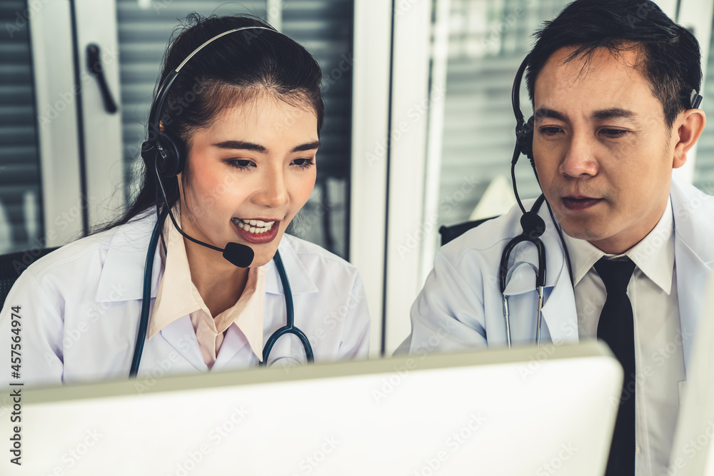 Doctor team wearing headset talking actively on video call in hospital clinic . Concept of telehealt