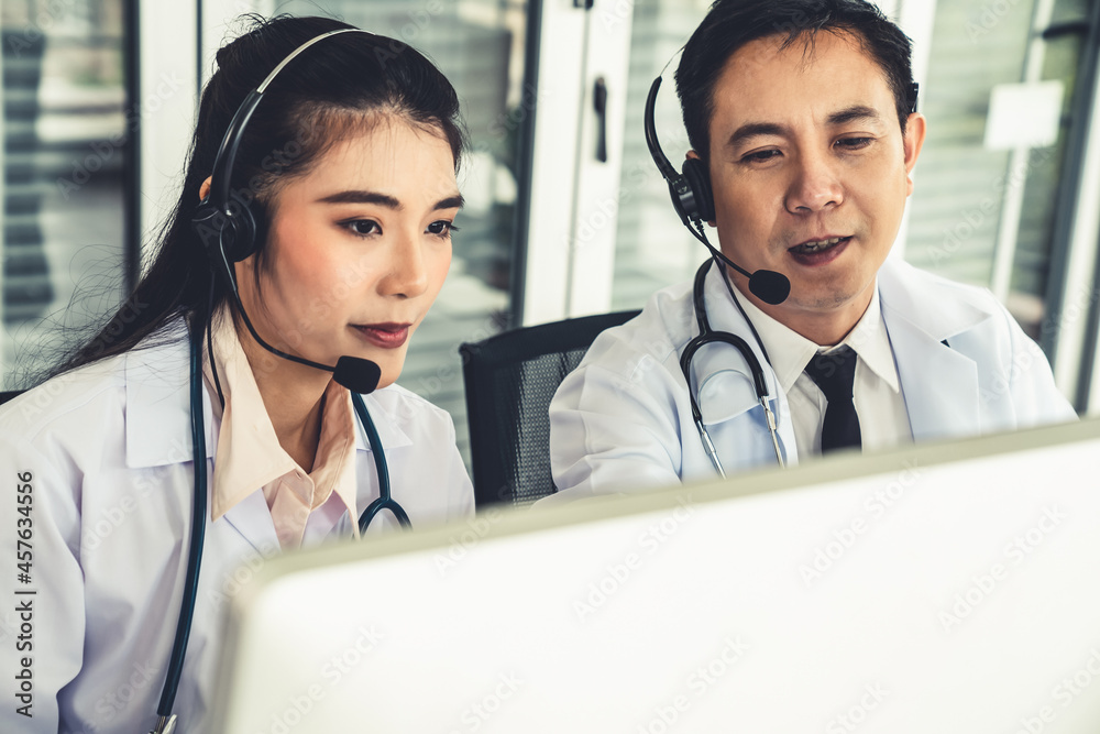 Doctor team wearing headset talking actively on video call in hospital clinic . Concept of telehealt