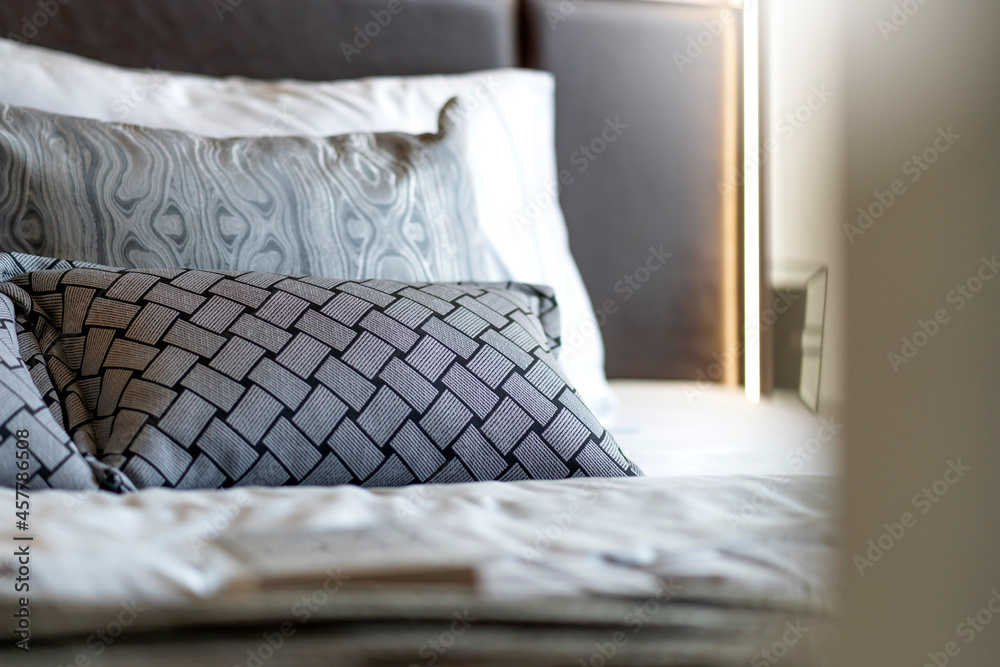 close up soft beatiful bedroom pillows arrange setting in hotel bedroom with morning light from wind