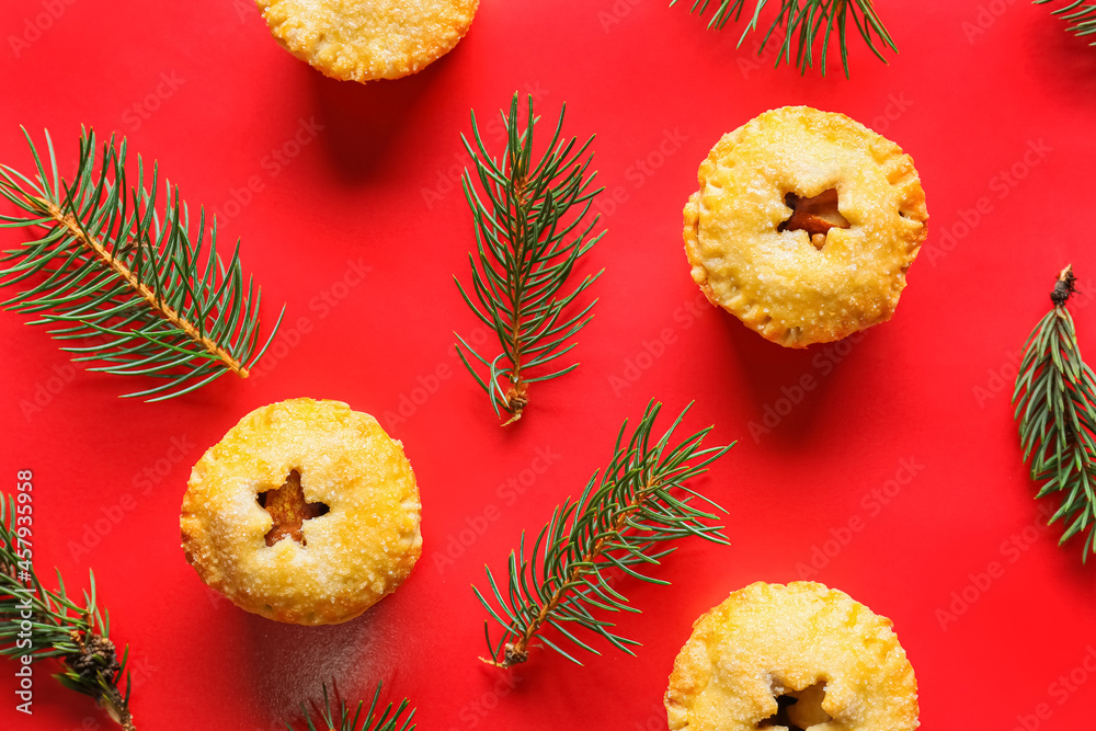 Christmas mince pies with fir branches on color background