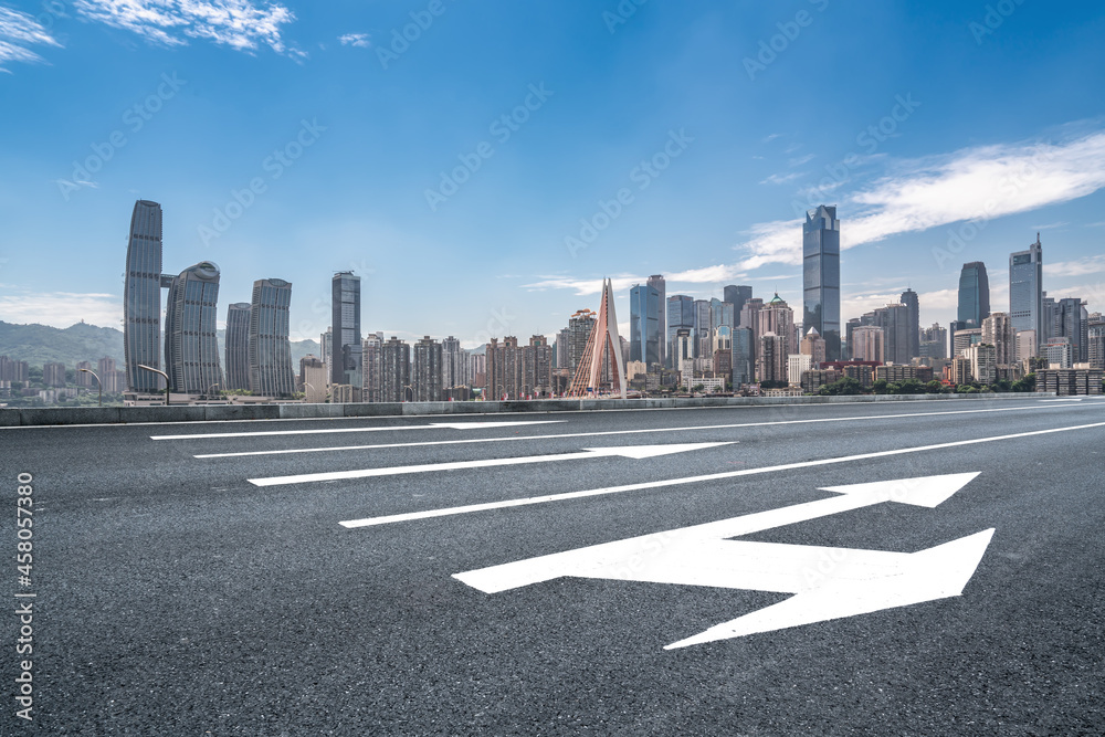 Panoramic skyline and empty asphalt road with modern buildings