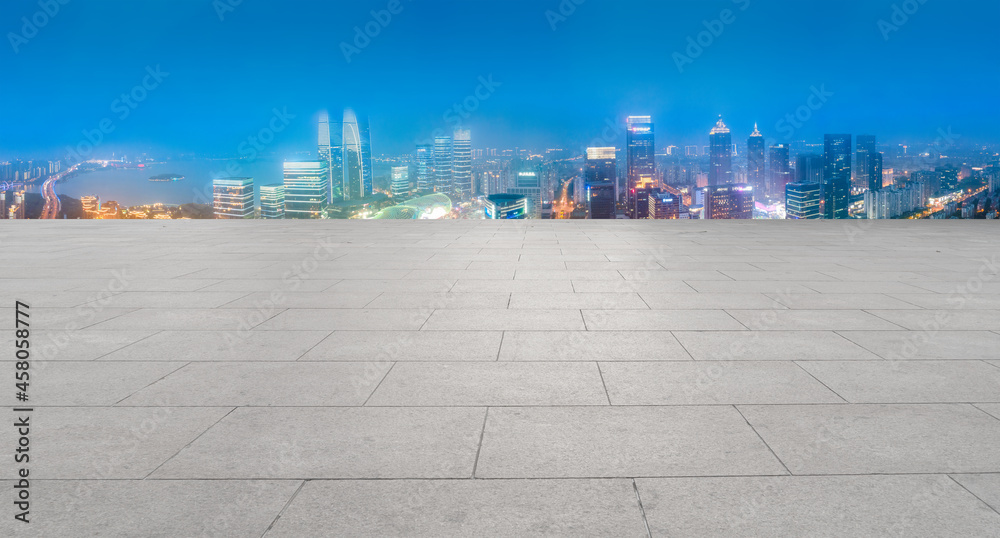 Panoramic skyline and empty square floor tiles with modern buildings