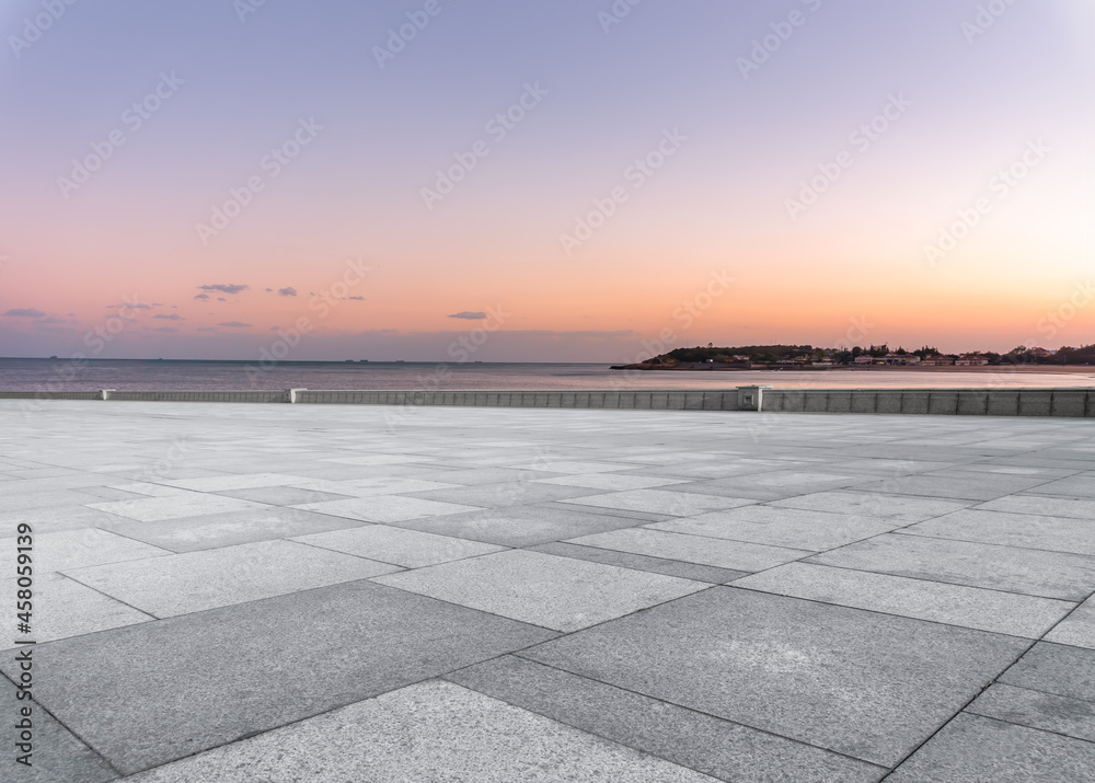 Panoramic skyline and empty square floor tiles with modern buildings