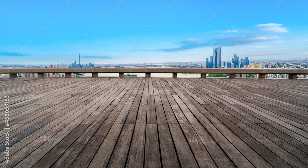 Panoramic skyline and empty square floor tiles with modern buildings