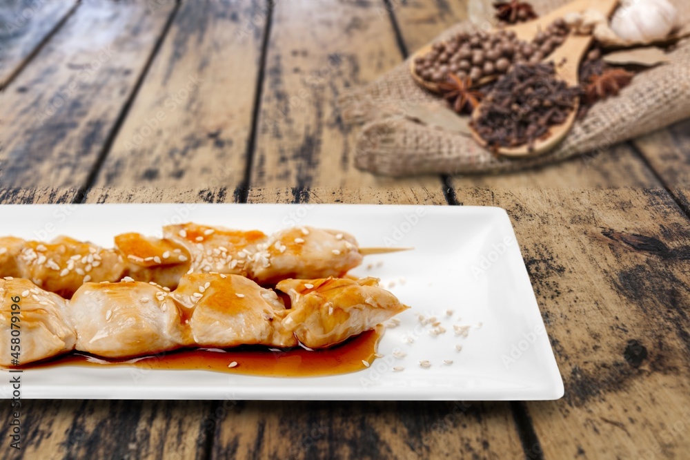 Grilled tasty cheese on a wooden board with sugar syrup and pepper.