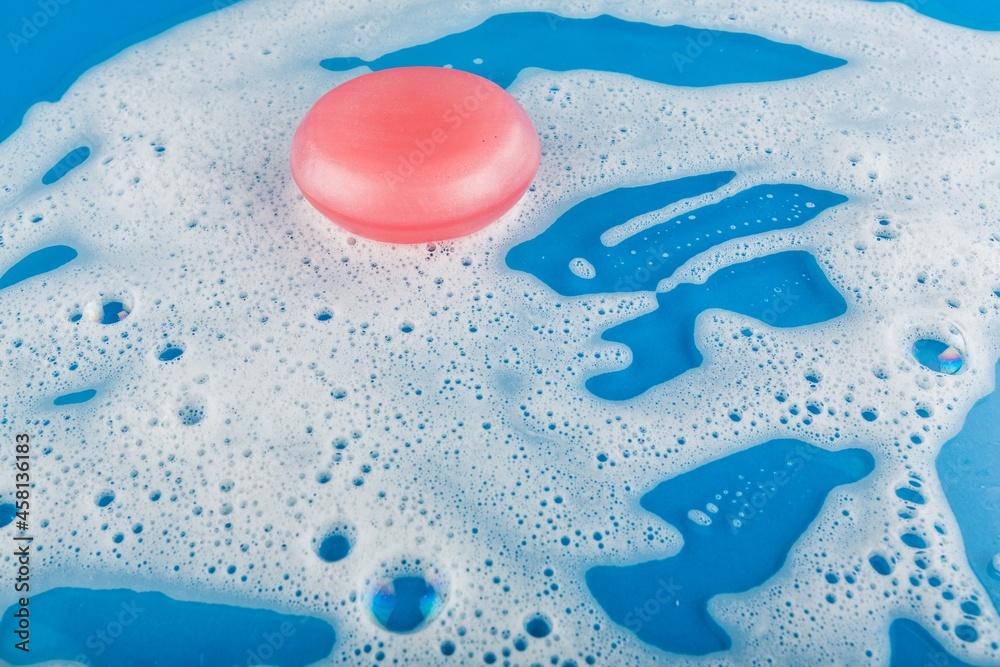 Bar of colored Soap on white bubbles