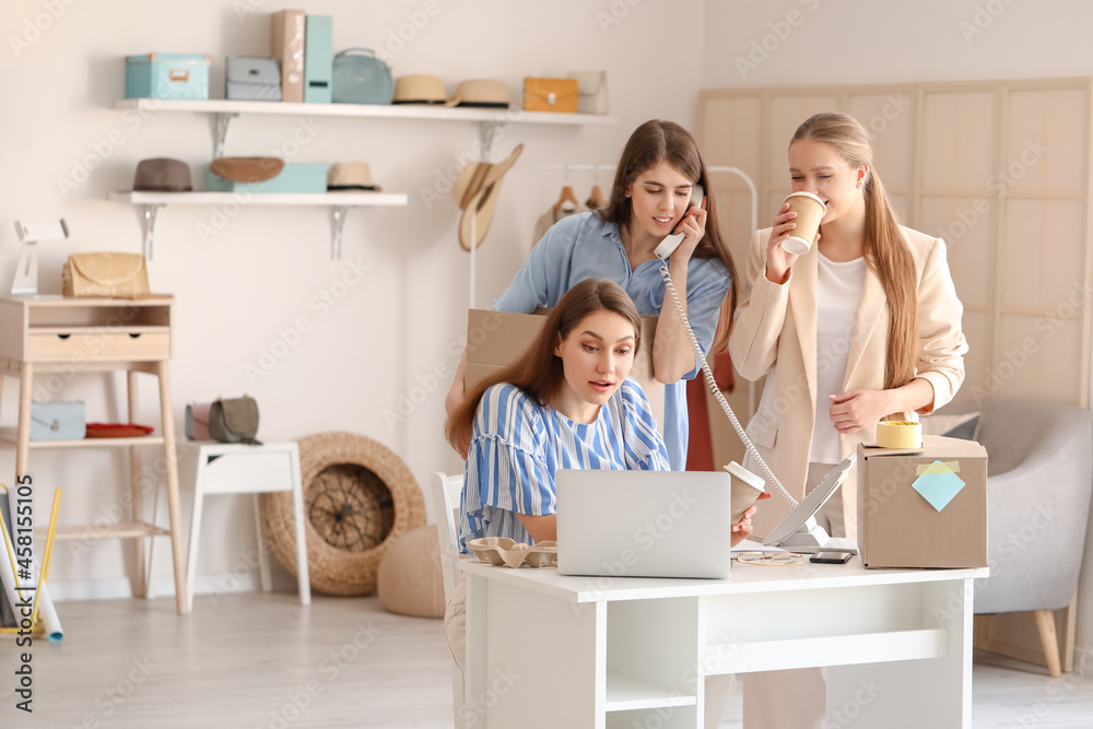 Female business owner and sellers working in shop