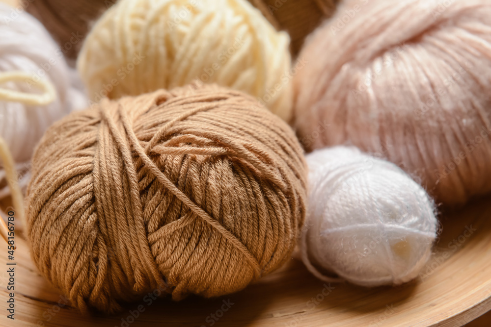 Wooden board with knitting yarn, closeup