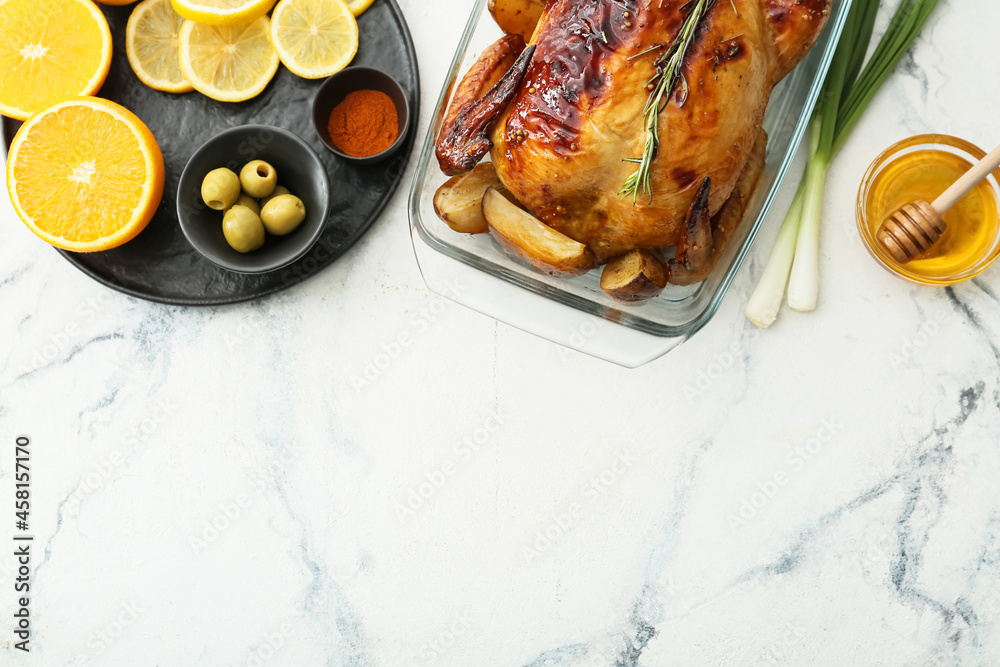 Baking dish with tasty chicken, orange, lemon, honey and vegetables on light background