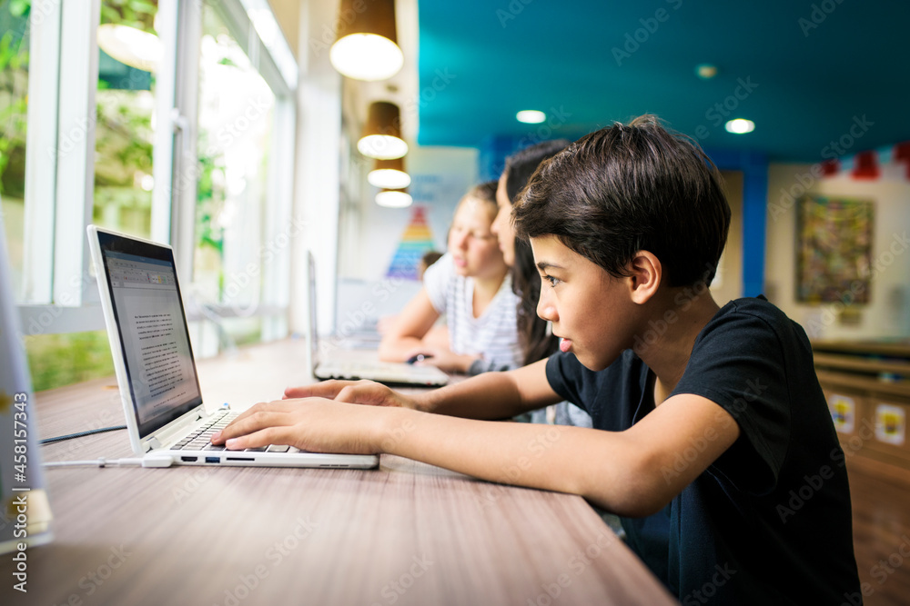 Group of students using laptop