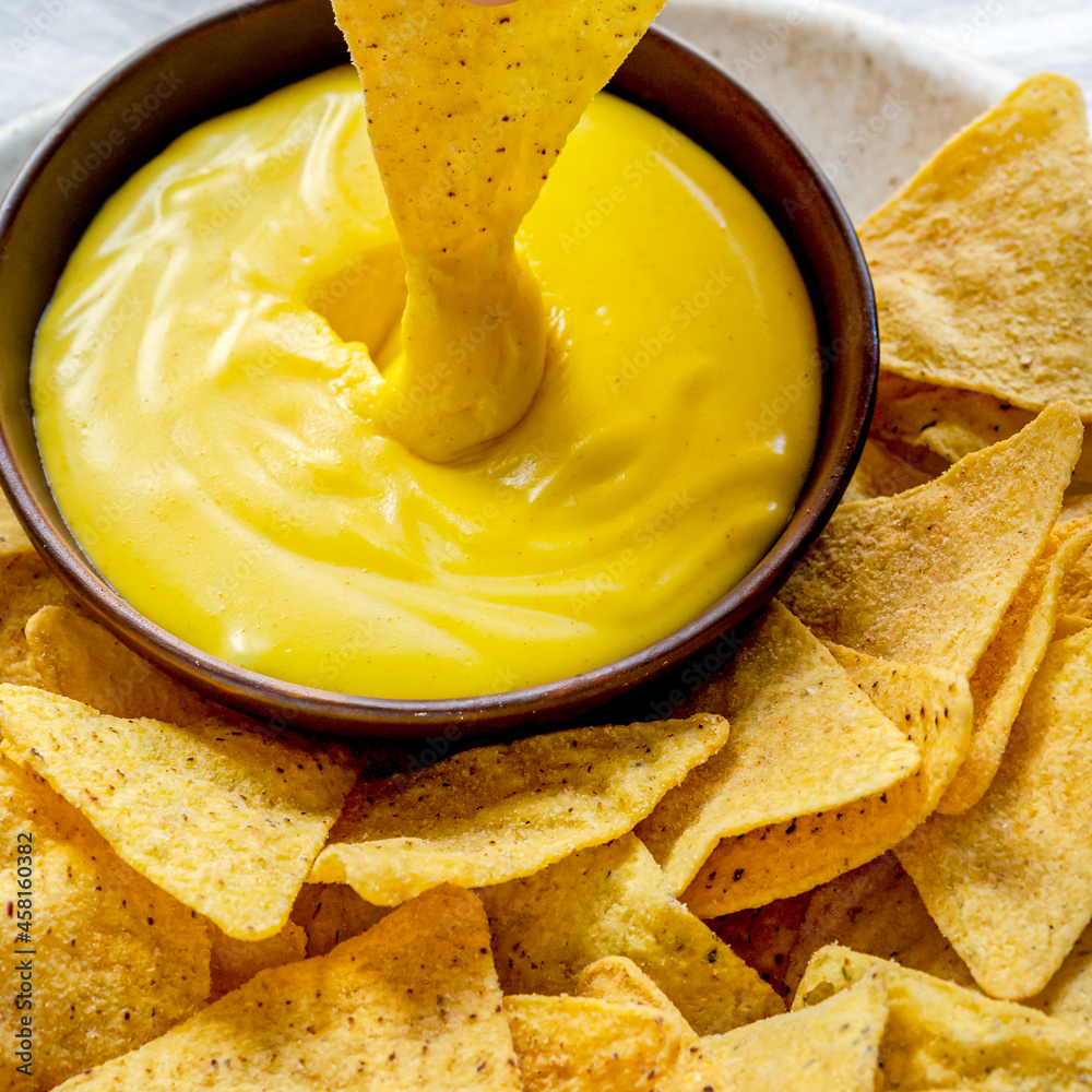 Tex mex corn tortilla chips with cheddar cheese dip