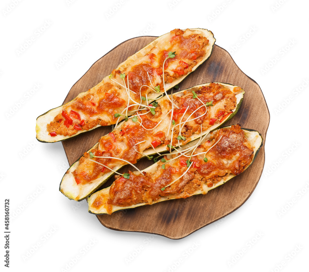 Wooden board with meat stuffed zucchini boats on white background