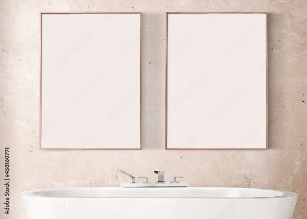 Blank picture frames hanging over a bathtub in luxury bathroom interior design