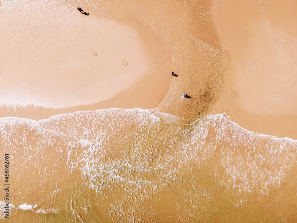 Aerial view of sandy beach and ocean with waves