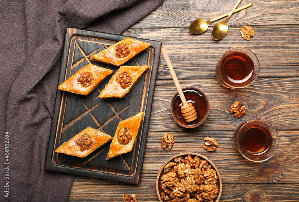 Composition with tasty baklava on wooden background