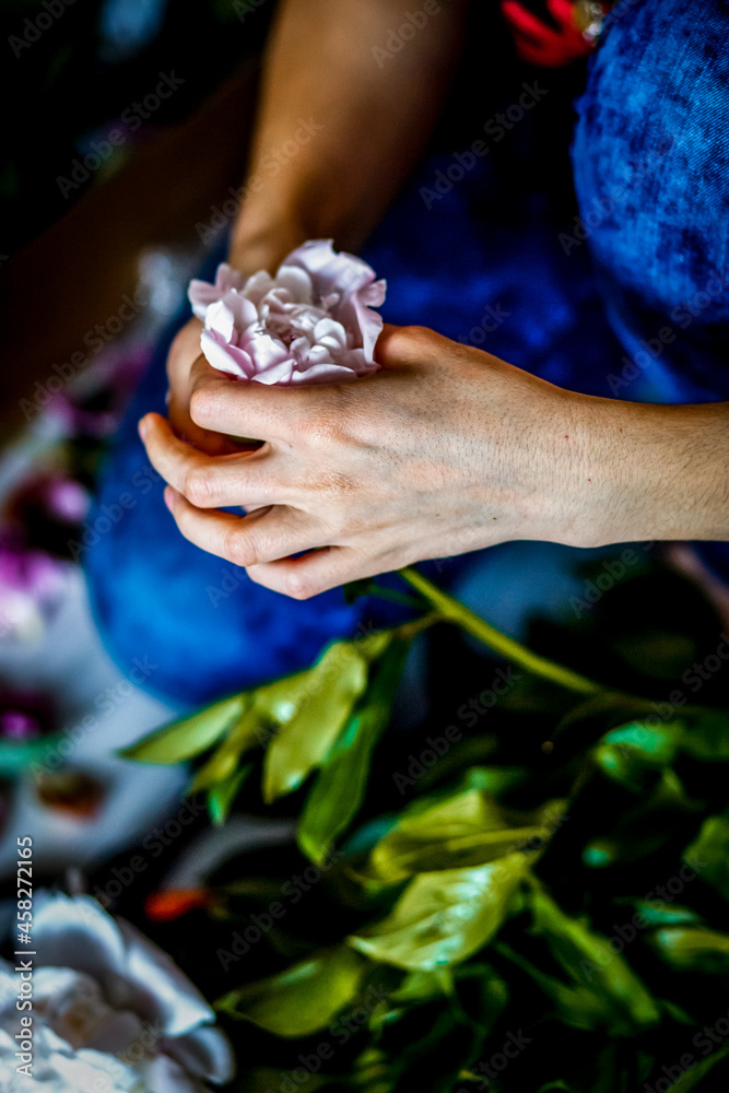 Florist making a bouguet of peonies