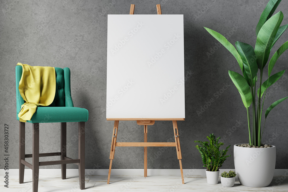 Blank canvas on wooden easel with plant