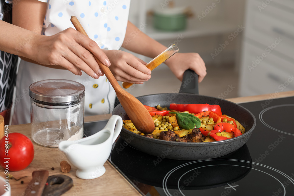 年轻的母亲和女儿在家的厨房里一起做饭