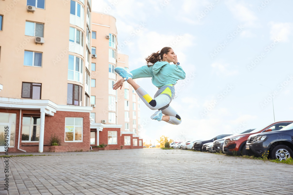 Sporty young woman training outdoors