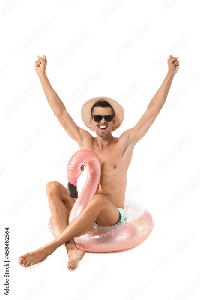 Young man with inflatable ring on white background