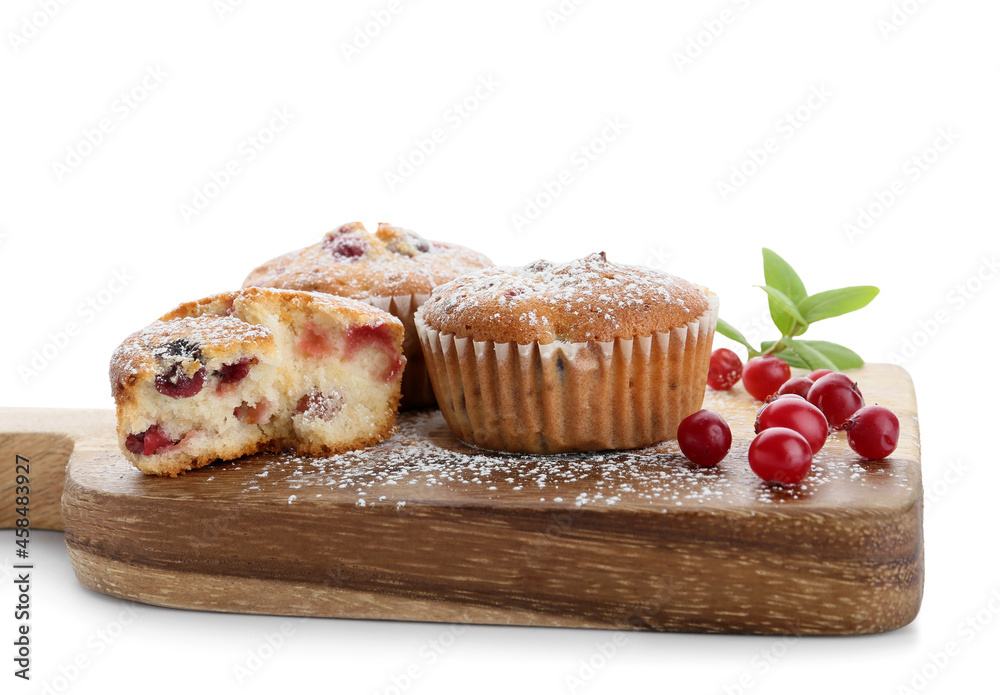 Wooden board with tasty cranberry muffins on white background