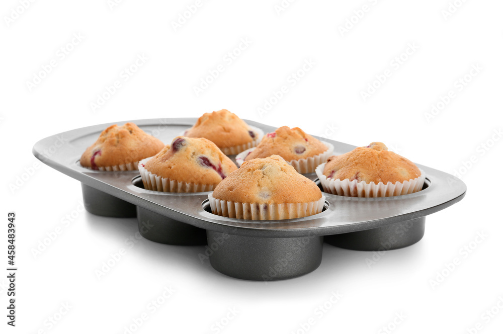 Baking tin with tasty cranberry muffins on white background