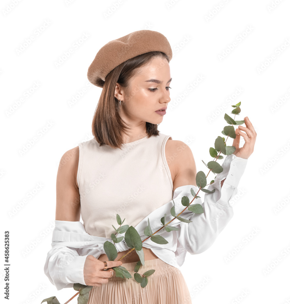 Beautiful young woman with eucalyptus branch on white background