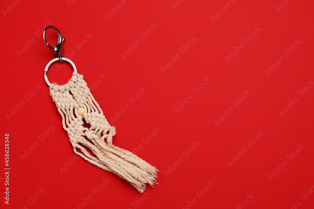 Handmade cotton keychain on color background