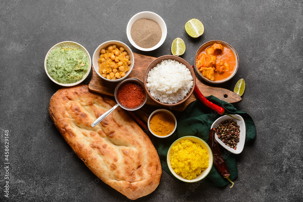 Traditional Indian food with spices on dark background