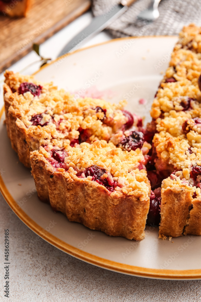 Plate with tasty cherry pie on light background, closeup