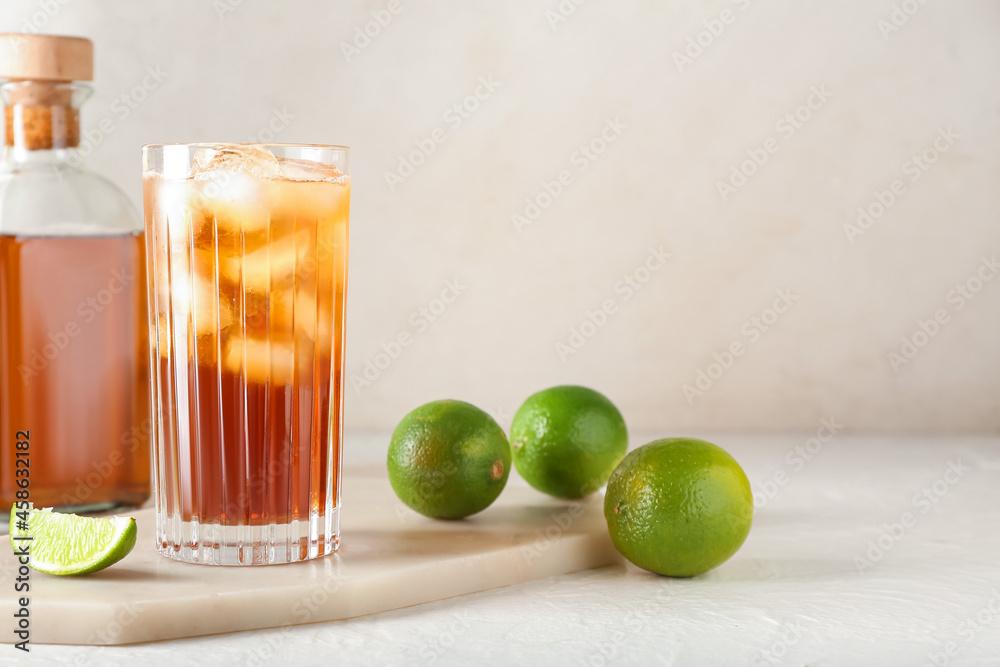 Glass of tasty Long Island iced tea on light background, closeup