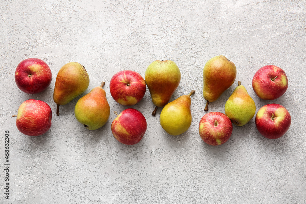 Ripe pears and apples on light background