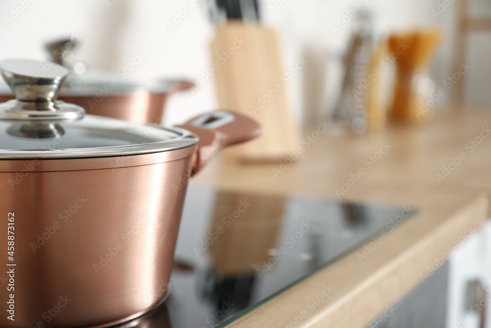 Copper cooking pot on stove in kitchen, closeup