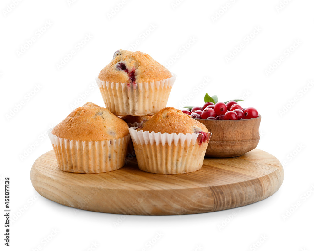 Wooden board with tasty cranberry muffins on white background