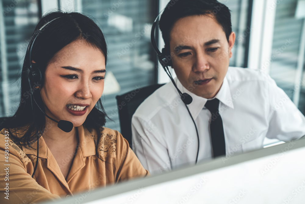 Business people wearing headset working actively in office . Call center, telemarketing, customer su