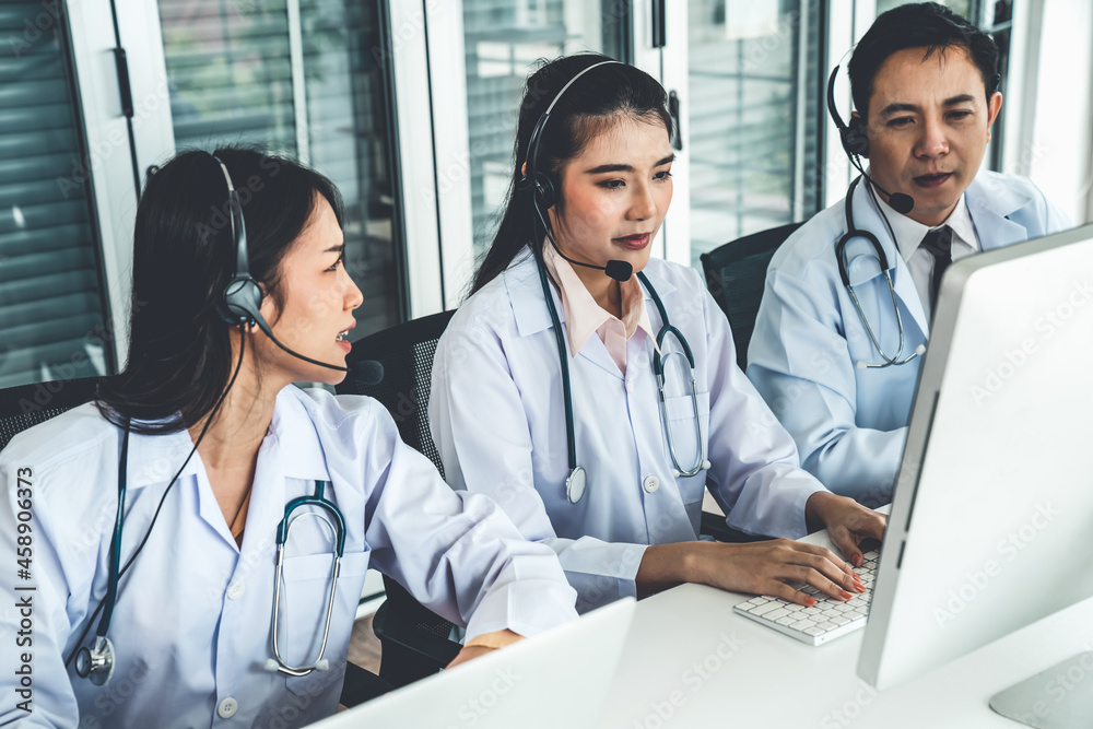 Doctor team wearing headset talking actively on video call in hospital clinic . Concept of telehealt