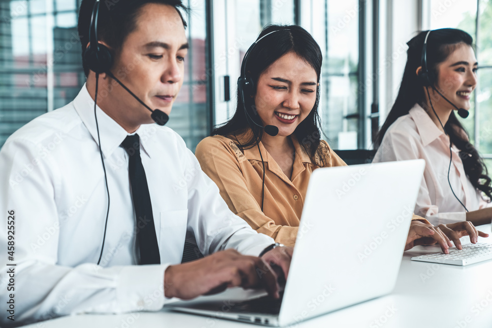 Business people wearing headset working actively in office . Call center, telemarketing, customer su