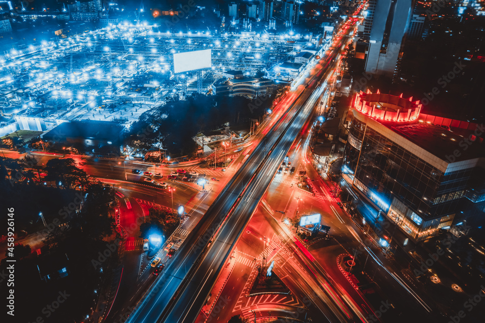 Busy highway road junction in metropolis city center at night . Transportation and infrastructure co