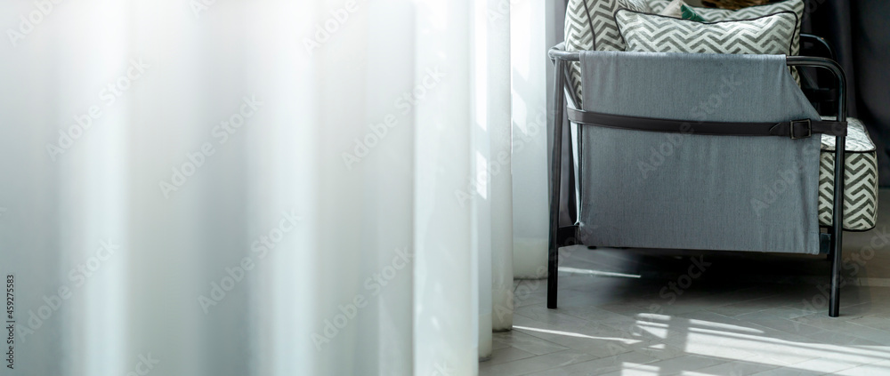 contemporary interior of Living room with part of sofa in sunny day and white curtain interior backg