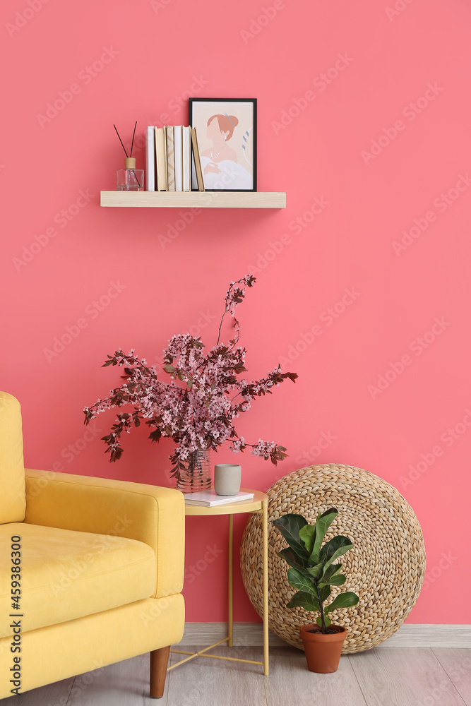 Blossoming branches in interior of stylish living room