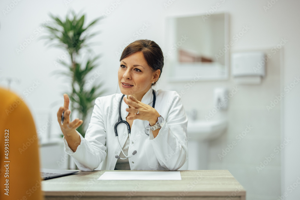 Doctor talking to a patient in private practice office.