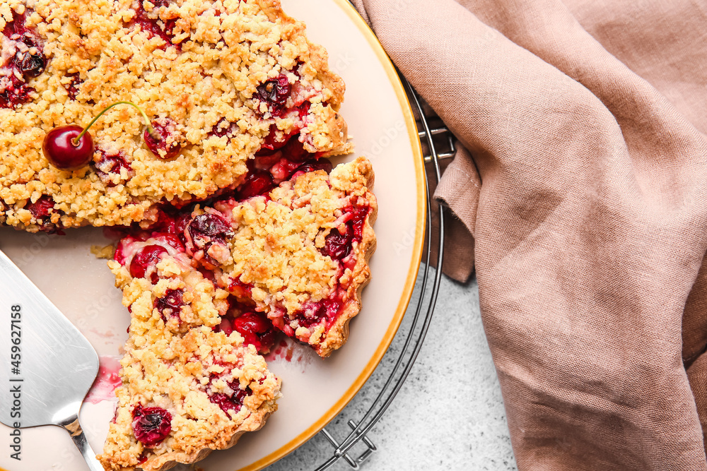 Plate with tasty cherry pie on light background, closeup