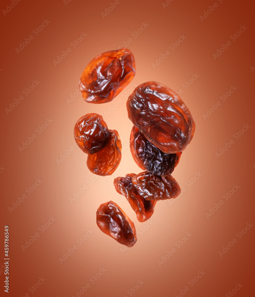 Raisin close up in the air on a brown background