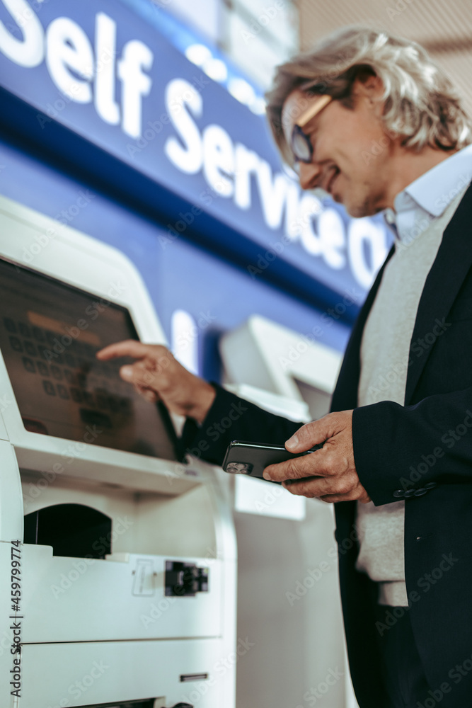 Mature businessman doing check in at airport