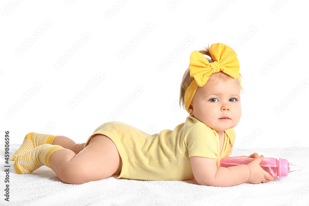 Cute baby girl with bottle of water on white background